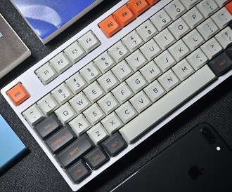 Keyboard image with orange, white, and dark gray Key-caps